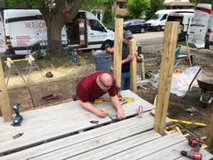 construction worker measuring on deck