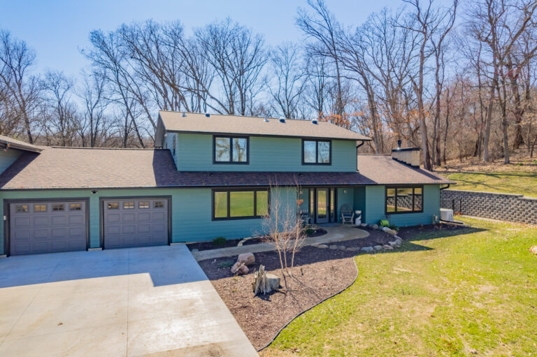 Front view of a home remodel customer in Fitchburg Wisconsin. Front landscape has stones around the walkway from the driveway