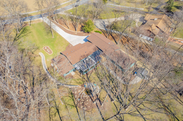 Arial view of a home remodel in Wisconsin. Backyard shows landscaping going to the front and multiple additions.